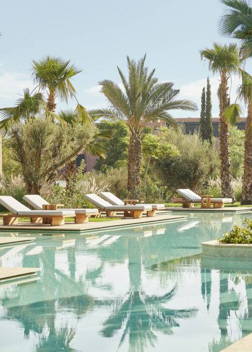 MARPH-SWIMMING-POOL-OASIS-PALM-TREES-SUN-BEDS-OUTSIDE-RESORT